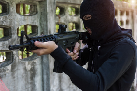 Commando with Helmet holding M16 gun points already shootの写真素材
