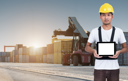 Foreman stand show tablet on front forklift loading Containers box to Logistic cargo Import Exportの写真素材