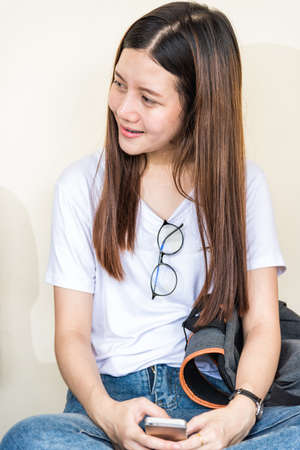 Young woman sitting useing with technology at universityの写真素材