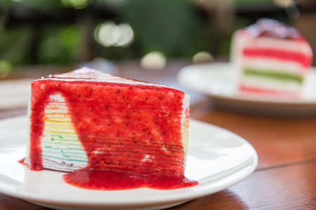 Sliced tasty strawberry cake on wooden table backgroundの写真素材
