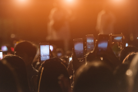 Event people live video festival music concert by hand holding smart mobile phoneの写真素材