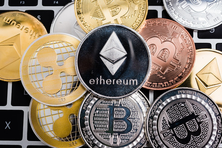 Virtual ripple XRP, Ethereum and Bitcoin coins currency finance money stack together on computer...