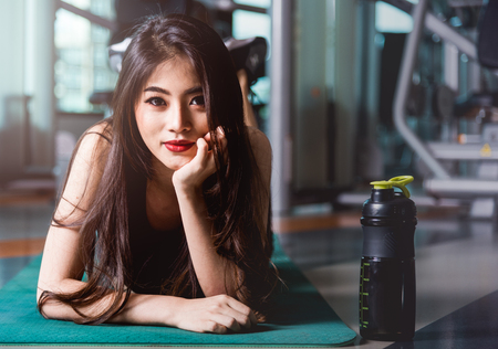 Happy young beautiful woman lifestyle sport portrait training workout exercise cardio at fitness gymの写真素材