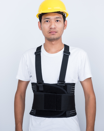 Worker Man stand wearing back support belt body protect postureの写真素材
