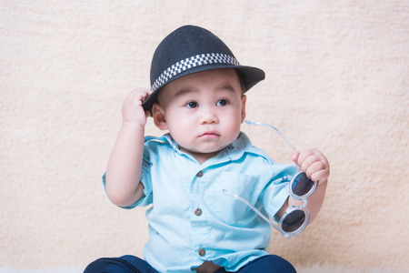 Fashionable funny child baby boy with sunglassesの写真素材