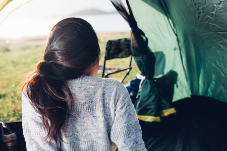 Young Woman camping in forest on summerの写真素材