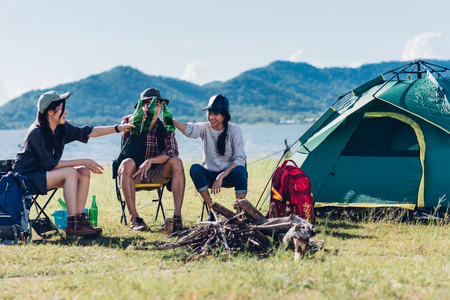 Youth friends camping together in forest on summerの写真素材