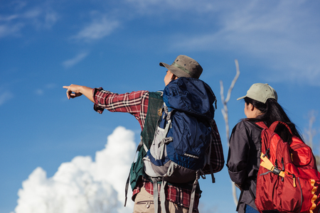 Happy young couple walking hiking in forest for camping tent together on outdoor holiday summerの写真素材