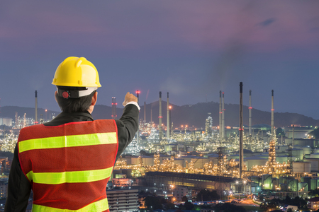 Petrochemical engineering man with white safety helmet standing in oil refinery building structure petrochemical industryの写真素材