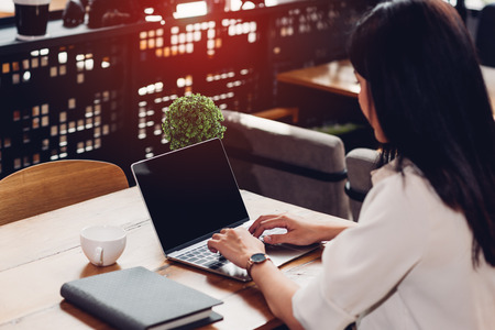 Business young female lifestyle freelance working using on laptop computer in coffee shopの写真素材