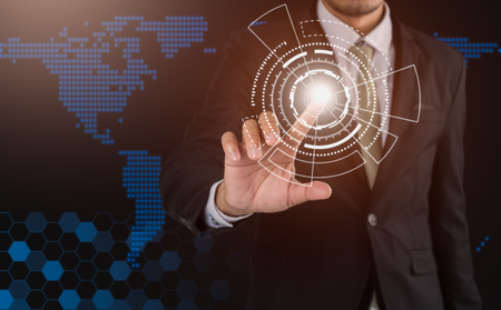 Businessman touches finger button on digital technology screenの写真素材