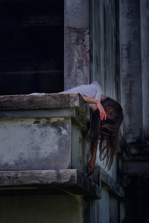 Zombie Ghost woman murder underhung head on abandoned building with bloody ,halloween conceptの写真素材