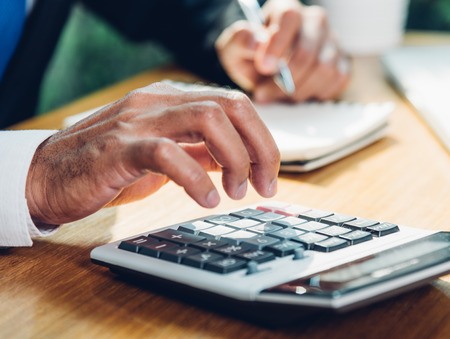 Business man accounting using calculating and work with laptop computer on desk office, finance conceptの写真素材