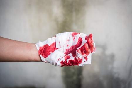Medicine bandage with very bloody red injury man hand after accidentの写真素材
