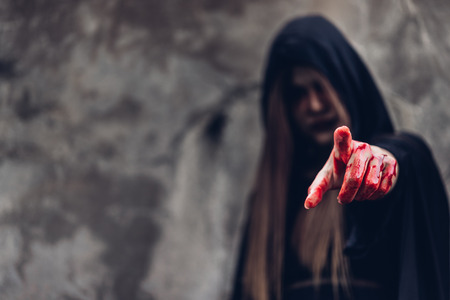 Portrait woman ghost devil she has point finger out and hand have red blood, halloween conceptの写真素材