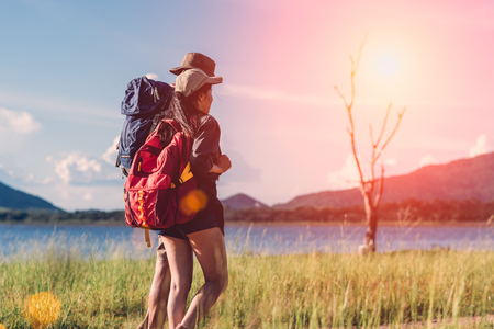 Camping camp in nature happy couple have backpack walking in summer at nature forestの写真素材