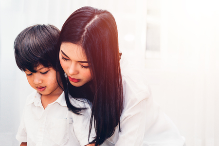 Child kid boy kindergarten and beautiful mother at interior room homeの写真素材