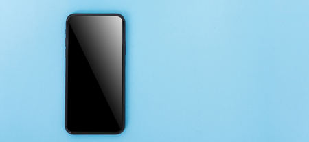 Top view of modern technology smart phone mobile on blue background with copy spaceの写真素材