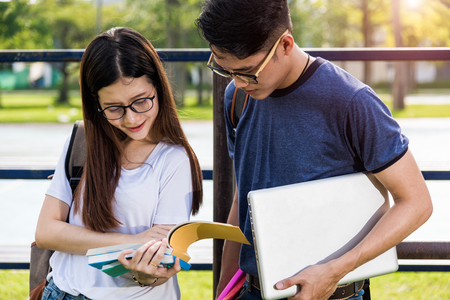 Education woman and man  or male female students are discussing after-school instructionの写真素材