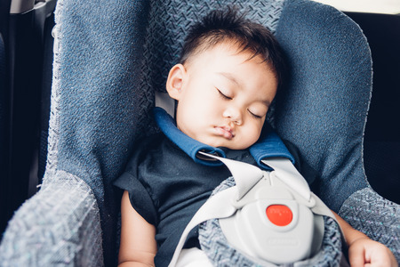 Asian baby boy travel in car seat and sleeping on the carの写真素材