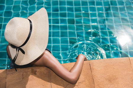Young woman sexy lifestyle luxury in bikini relaxing at resort, summer swimming pool water on holidaysの写真素材
