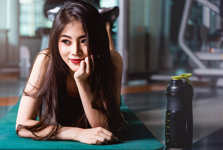 Happy young beautiful woman lifestyle sport portrait training workout exercise cardio at fitness gymの写真素材