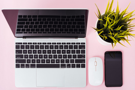 Top view of modern technology smart phone mobile and computer laptop on pink background with copy spaceの写真素材