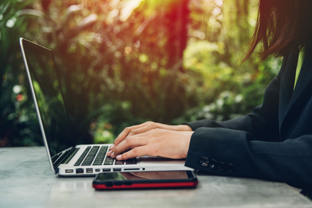 Business woman using his computer laptop on The desk is surrounded by natureの写真素材