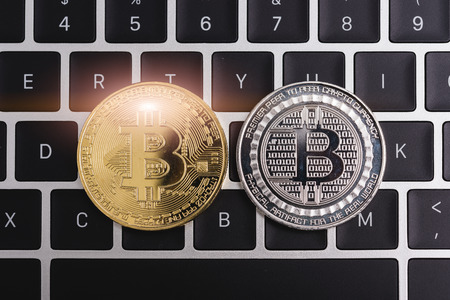 Virtual Bitcoin coin currency finance money on computer laptop keyboardの写真素材