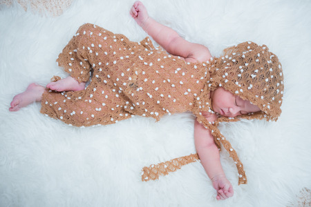Portrait newborn baby girl infant sleeping on bedの写真素材