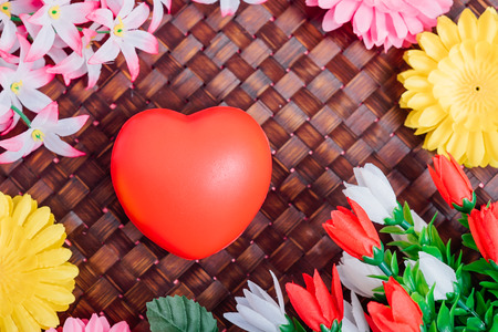 Flower and red heart on wooden background with copy space, valentine day conceptの写真素材