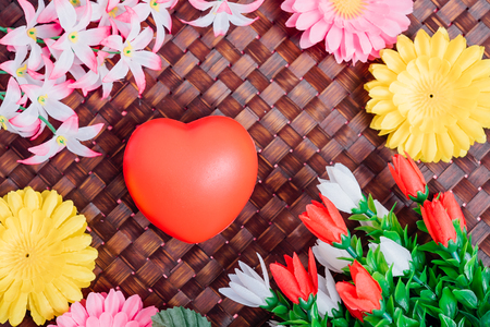 Flower and red heart on wooden background with copy space, valentine day conceptの写真素材