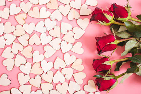 Wood hearts on pink background have a flower rose, valentine day conceptの写真素材