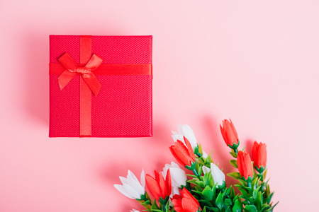 Fower and gift box on pink background with copy space, valentine day conceptの写真素材