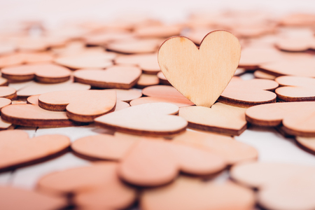 Wood hearts stand on white wooden background with copy space, valentine day conceptの写真素材