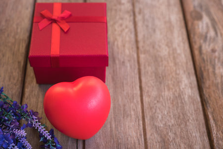 Red heart, flower and gift box on wooden background with copy space, valentine day conceptの写真素材