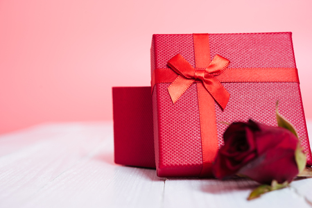 Gift box and flower roses on white wooden background, valentine day conceptの写真素材