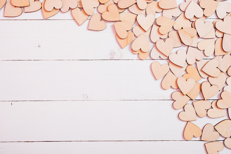 Wood hearts on white wooden background with copy space, valentine day conceptの写真素材