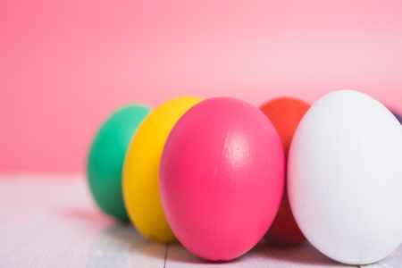 Easter eggs clean on wooden and pink background, easter day conceptの写真素材