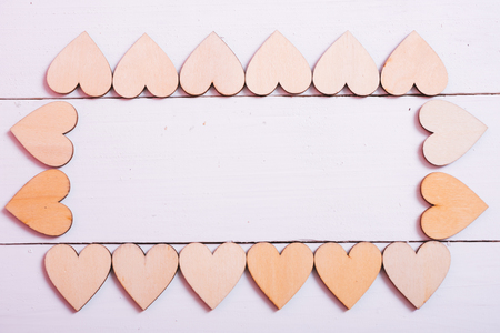 Wood hearts on white wooden background have frame copy space, valentine day conceptの写真素材