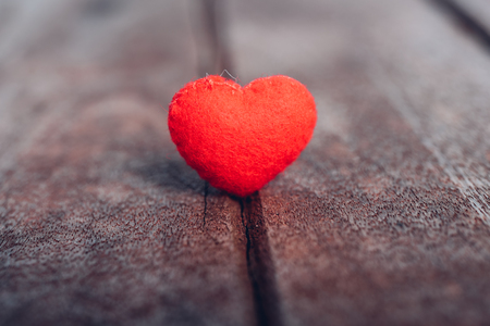 Red heart stand on wooden background, valentine day conceptの写真素材