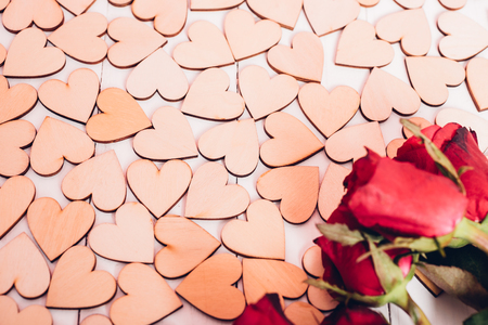 Wood hearts and red roses on white wooden background have frame copy space, valentine day conceptの写真素材
