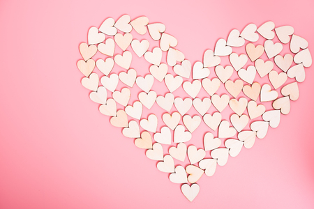 Wood hearts on pink background, valentine day conceptの写真素材