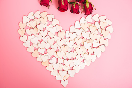 Wood hearts on pink background have a flower rose, valentine day conceptの写真素材