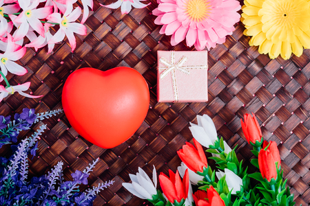 Red heart, flower and gift box on wooden background with copy space, valentine day conceptの写真素材