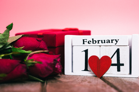 Red wood Hearts and gift box on wooden and pink background, 14 February, valentine day conceptの写真素材