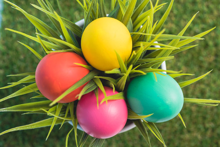 Top view of Easter eggs clean in grass on green  background, easter day conceptの写真素材