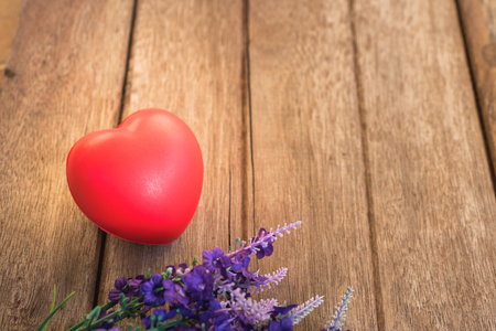 Red heart and flower on wooden background with copy space, valentine day conceptの写真素材