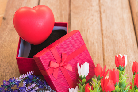 Red heart, flower and gift box on wooden background with copy space, valentine day conceptの写真素材