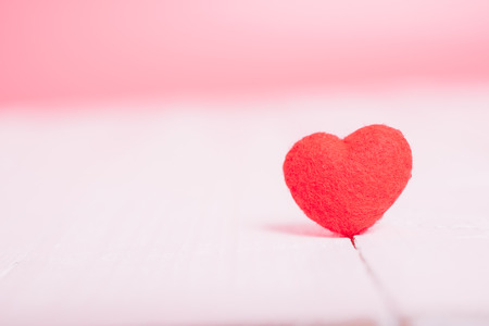 Red heart on white wooden have pink background, valentine day conceptの写真素材